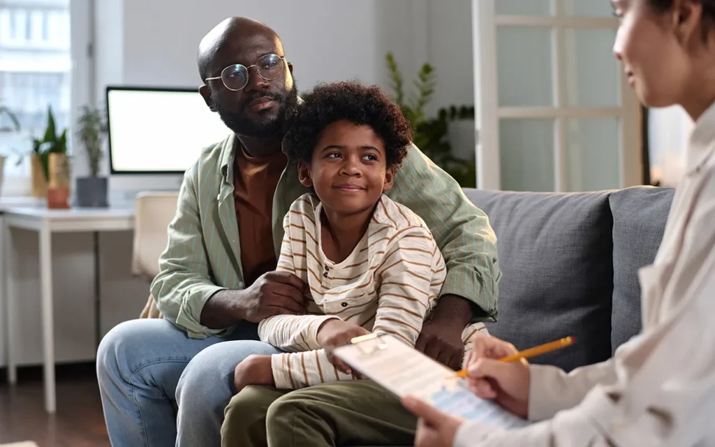 Father and son meeting with a counselor or therapist